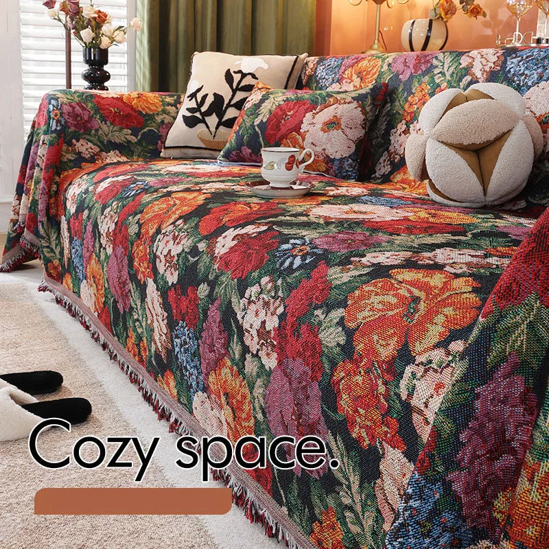 A richly colored floral jacquard sofa throw blanket featuring deep reds, oranges, purples, and greens.