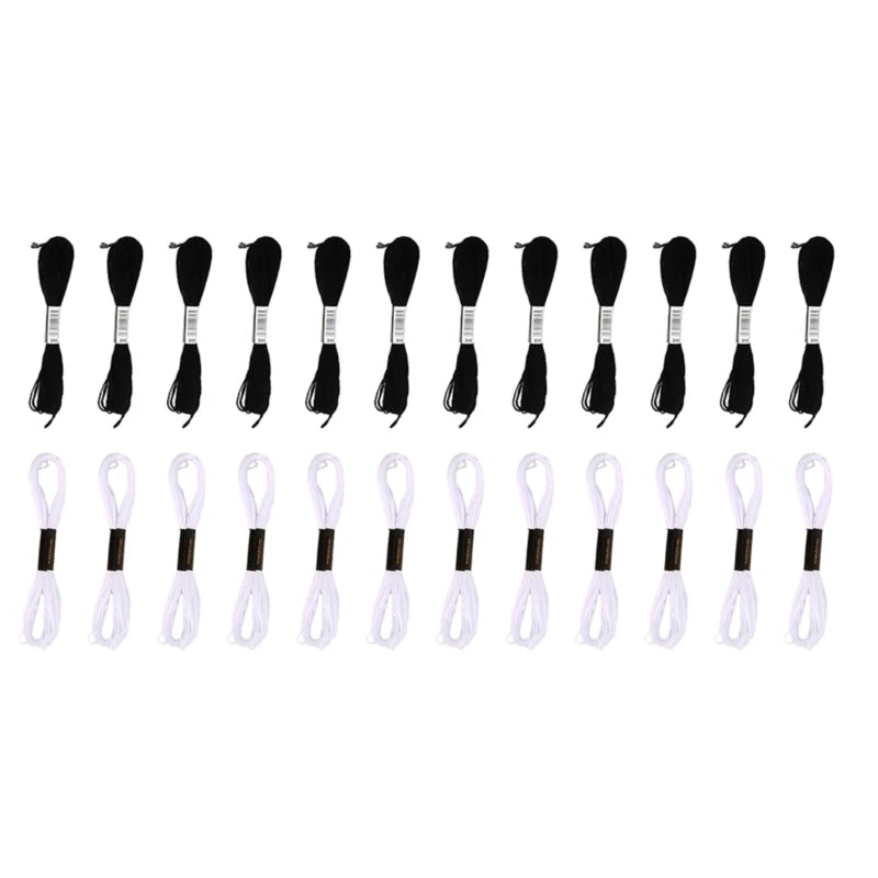 A set of white and black embroidery floss threads for craft work.