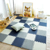 A blue and white checkered foam play mat with a cat painting on the wall.