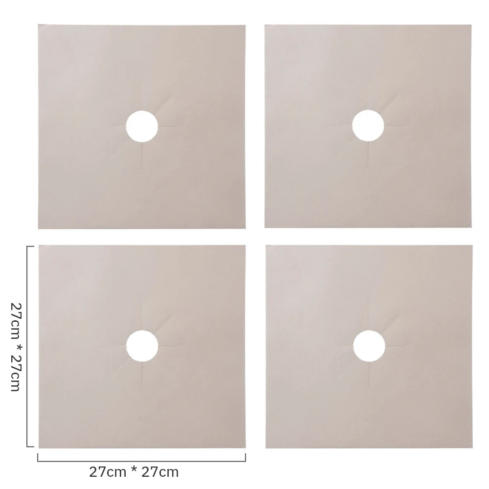A set of four square, light beige gas stove protectors with circular cutouts.