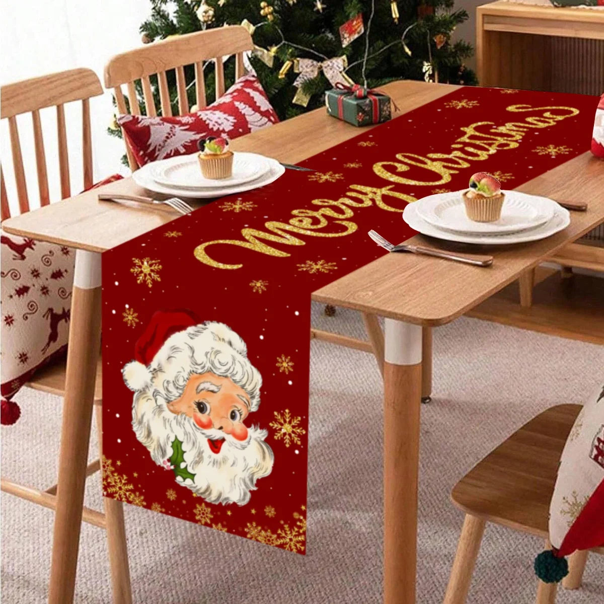 Festive Santa Christmas table runner featuring a red background with gold lettering and a white Santa face design.