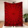 A red throw blanket featuring a black symmetrical spider web pattern.