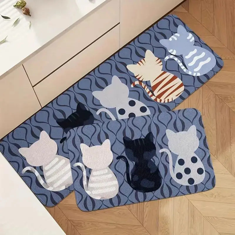 A rectangular blue mat featuring a pattern of various cats in white, gray, and black on a wooden floor.