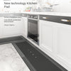 A black kitchen mat is shown placed on a marble floor in front of white cabinets and appliances.