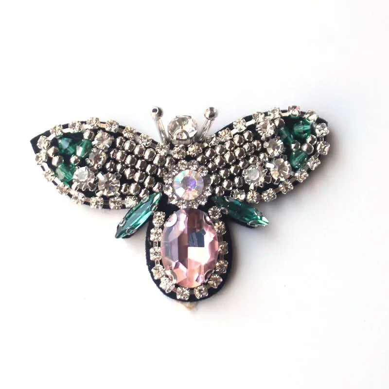 Handmade bee beaded sew-on patch featuring iridescent pink and green sequins and rhinestones