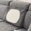 A gray sofa slipcover featuring a textured leaf pattern and a central white cushion.