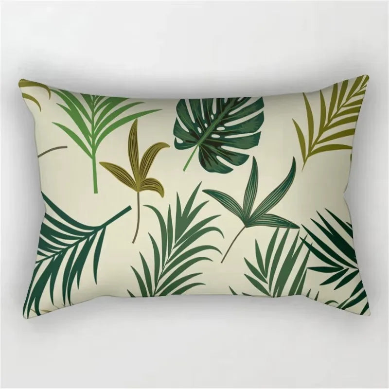 A rectangular pillowcase featuring a tropical leaf print in shades of green and olive on a beige background.