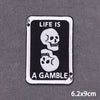 A black and white embroidered patch featuring a skull and the text Life is a gamble.
