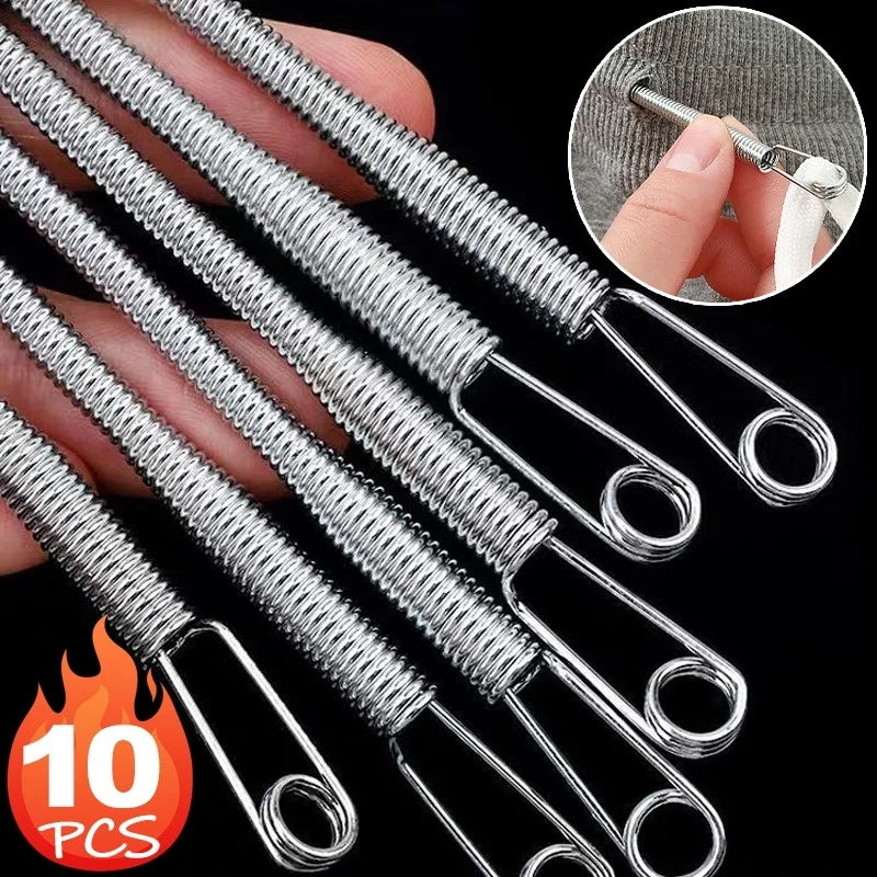A set of ten stainless steel rope threading and drawstring tools being held by a hand.