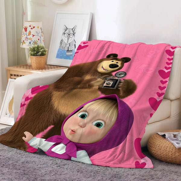 A plush fleece blanket featuring cartoon bears and a baby face design.
