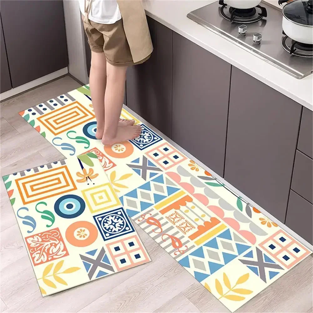 A set of two diamond print non-slip waterproof kitchen rugs displayed on a light wood floor next to dark cabinets.