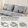 Gray pillowcases with a butterfly print and an envelope closure design shown on a bed.