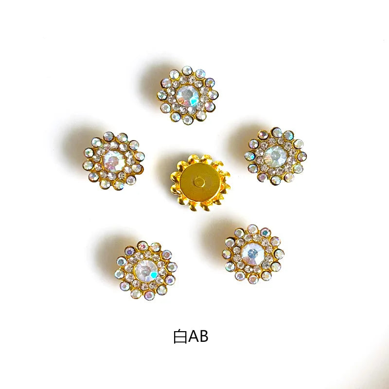 A collection of gold and clear rhinestone crystals in various flower shapes and sizes.