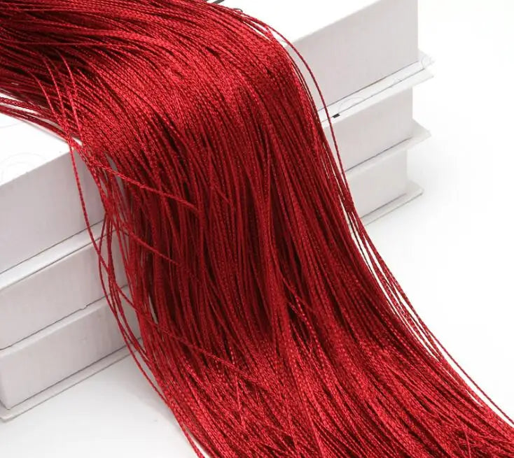 A close-up of a long, vibrant red thread curtain tie-back for doors and windows.