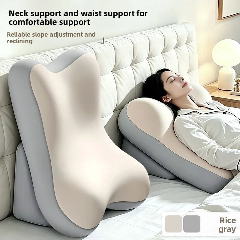 A beige ergonomic memory foam lumbar pillow is shown supporting the neck and waist for comfortable support on a bed.