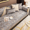 Gray velvet sofa cushion covers with gold foil detailing and cream accent pillows.
