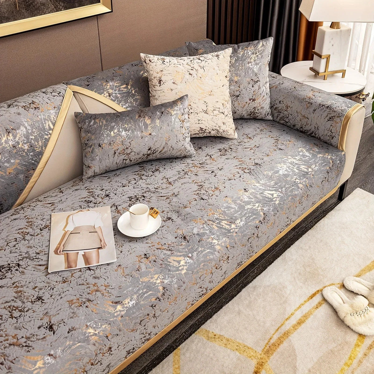 Gray velvet sofa cushion covers with gold foil detailing and cream accent pillows.