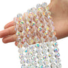 A hand holds a strand of multi-size shiny AB crystal glass beads for jewelry making