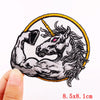 Embroidered skull iron-on patch featuring a fierce horse head with a horn and flowing mane on a yellow background