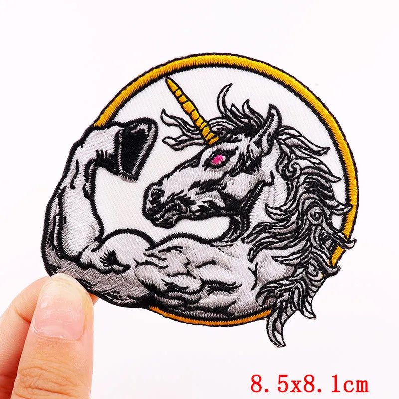 Embroidered skull iron-on patch featuring a fierce horse head with a horn and flowing mane on a yellow background