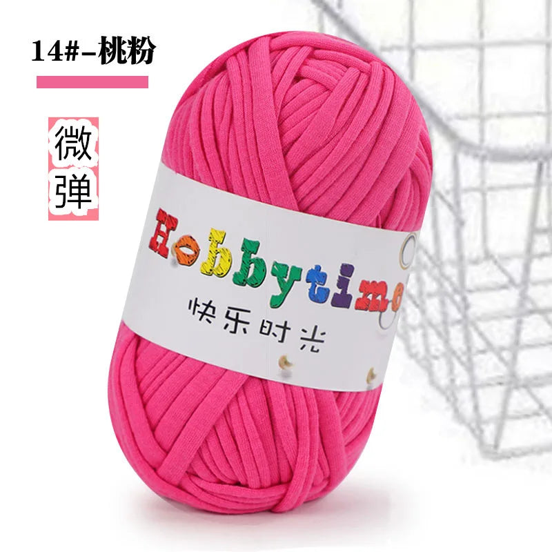 A ball of bright pink thick polyester craft yarn labeled Hobbytime for knitting and crochet
