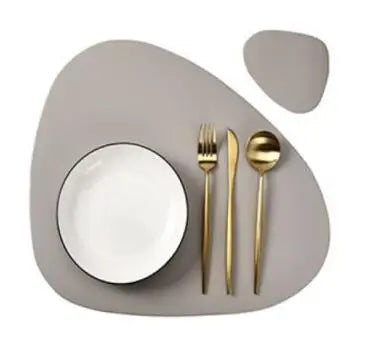 A set of reusable vinyl placemats and silverware displayed on a light gray plate.