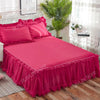 A vibrant pink princess lace bed skirt set with a bright pink duvet and pillows displayed on a bed.