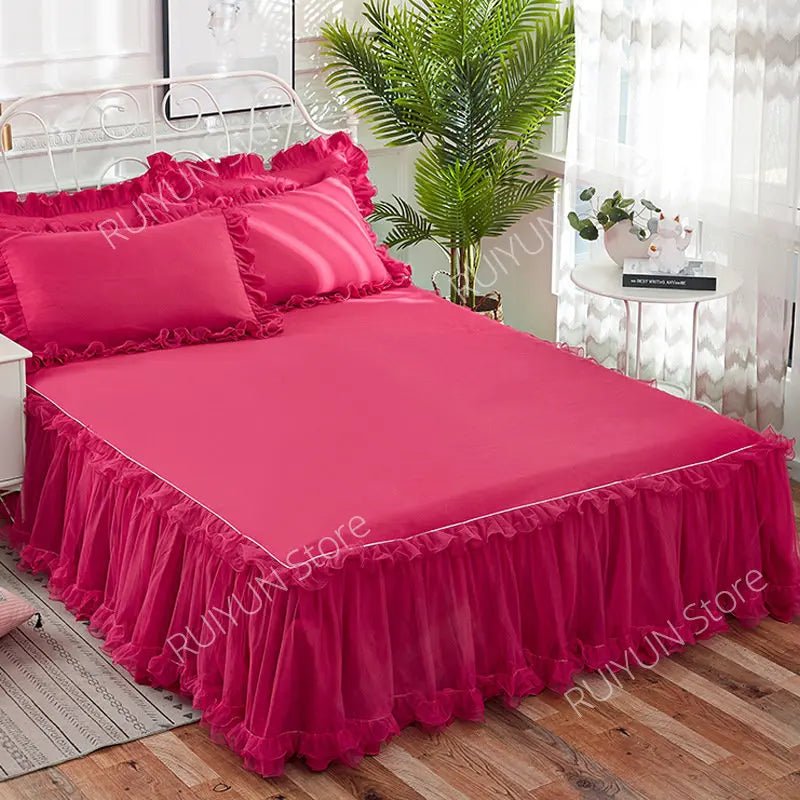 A vibrant pink princess lace bed skirt set with a bright pink duvet and pillows displayed on a bed.