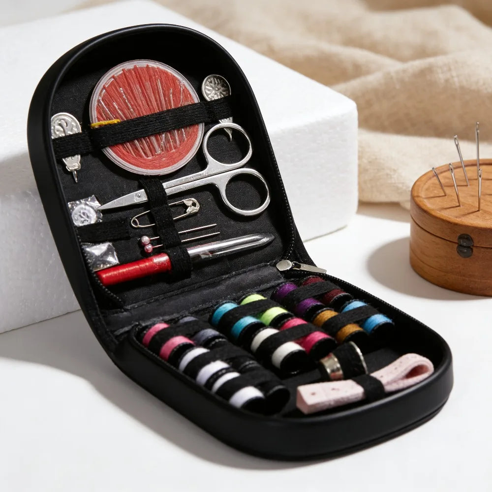 A black multi-functional sewing kit with various tools including scissors needles and thread spools is displayed on a white s
