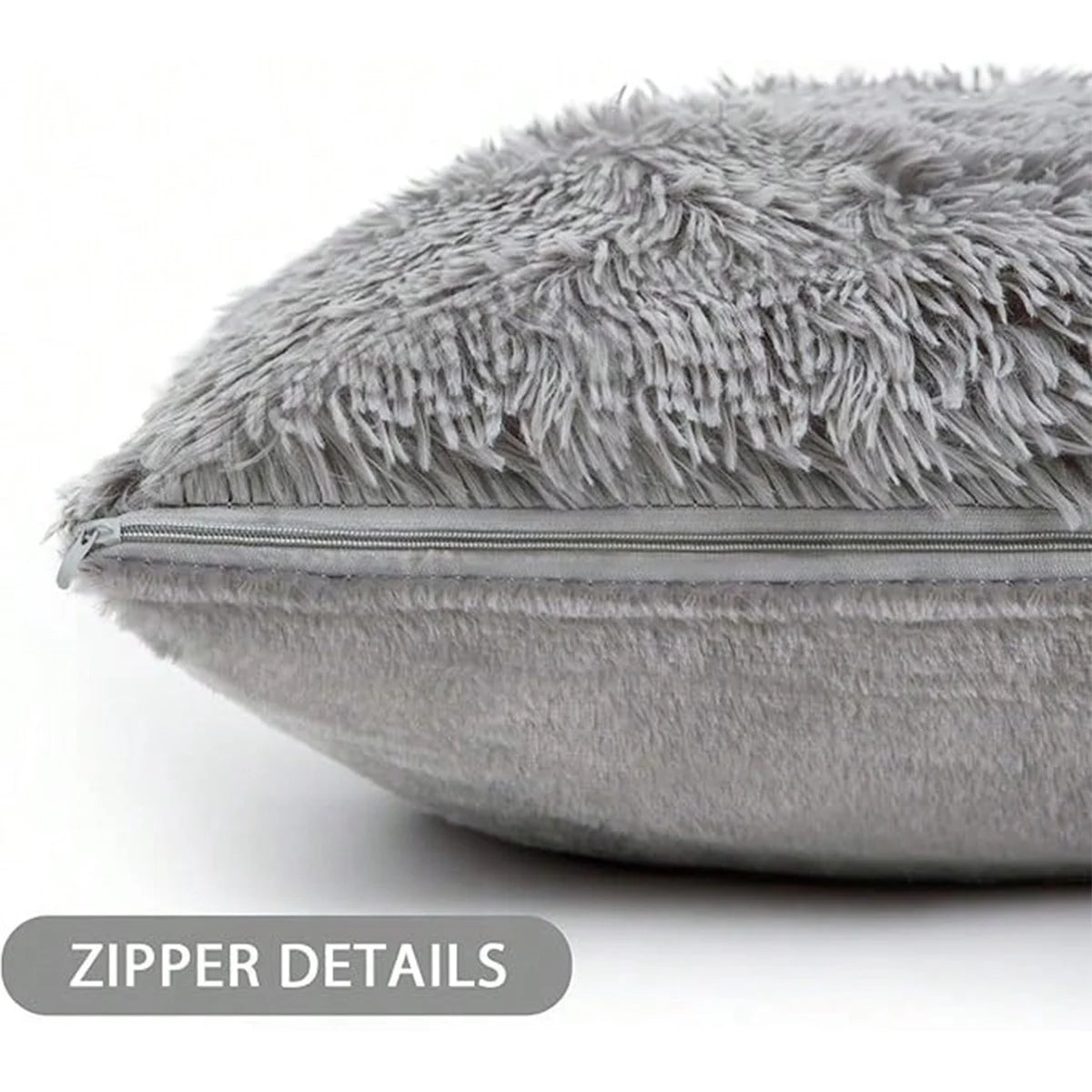 A close-up view of a gray faux fur throw pillow cover with visible zipper details.