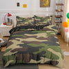 A camouflage duvet cover set featuring green, brown, and olive tones displayed on a bed.