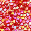 A close-up of a 100-pack of translucent red and pink acrylic heart beads for jewelry making.