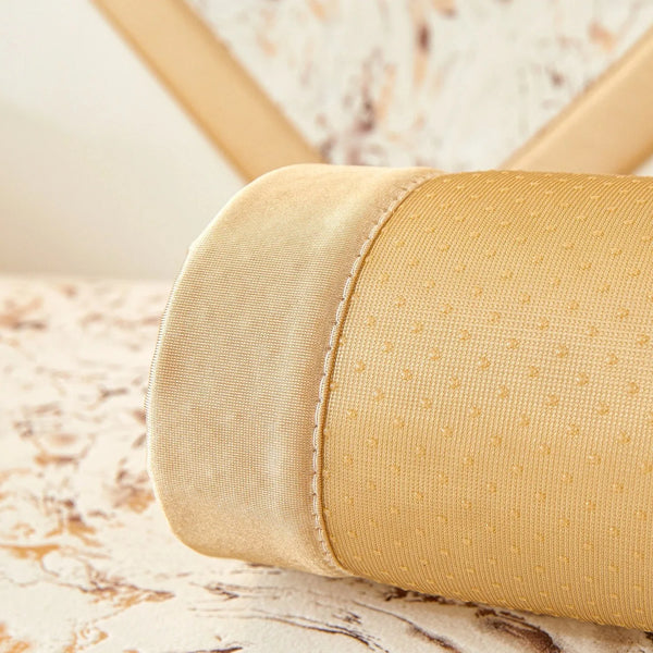 A close-up of a beige velvet sofa cushion cover with gold foil detailing.