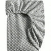 A close-up view of a soft plush mattress and diaper changing cover with a textured, quilted surface.