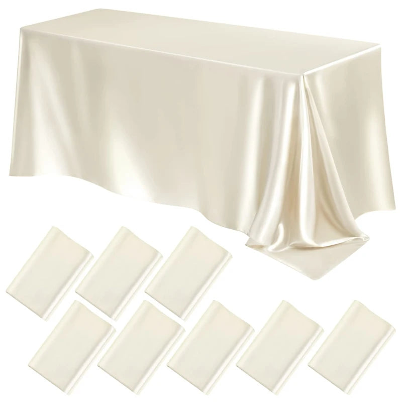 A rectangular ivory satin tablecloth draped on a table, showing soft folds and luxurious texture.