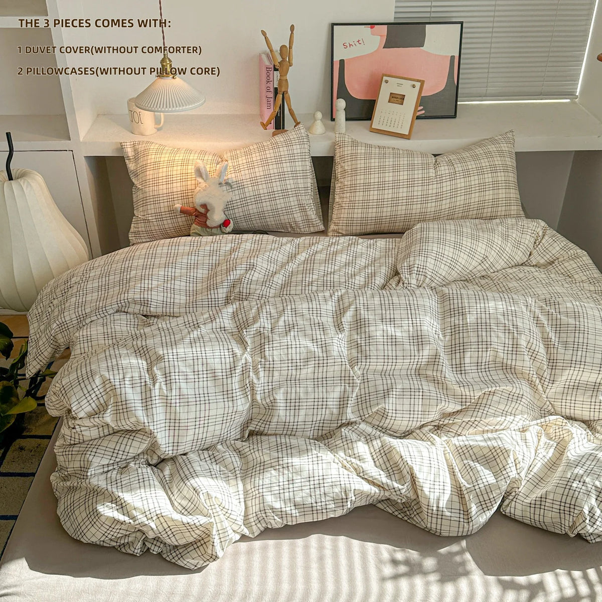 A beige plaid duvet cover set with matching pillowcases and decorative items displayed on a shelf.