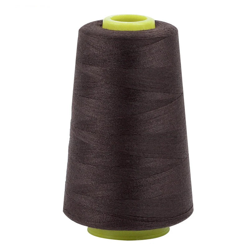 A roll of dark brown sewing thread with a light green cap.