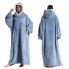 A person wearing a light blue ultra-soft plush fleece blanket hoodie with a hood and long sleeves.