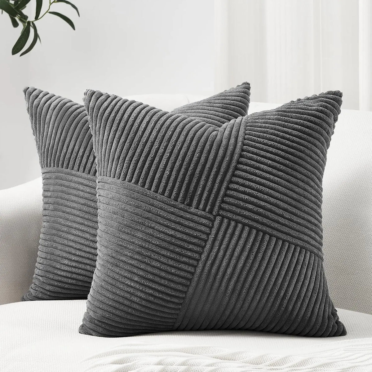 A textured gray corduroy throw pillow cover with vertical pleats and a diagonal pattern.
