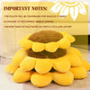A stack of yellow and brown sunflower-shaped throw pillows with important care instructions visible.