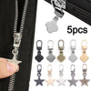 A close-up view of a black zipper with multiple metal zipper pull replacements, including a star shape, shown next to five in