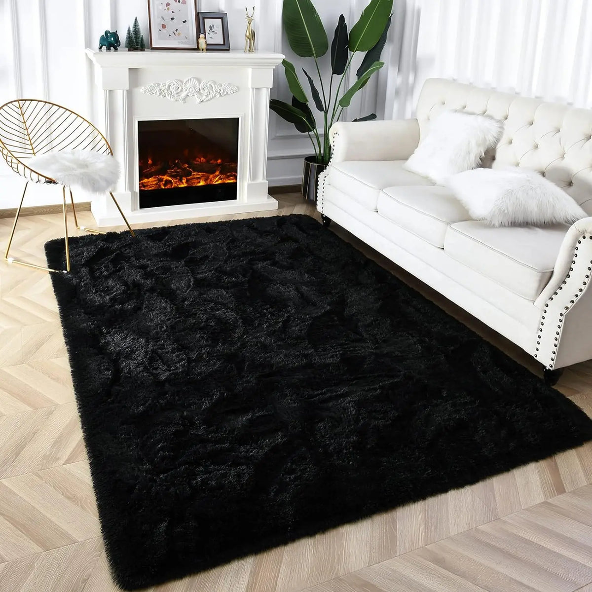 A black tie-dyed plush floor mat placed in front of a white fireplace and a white sofa.