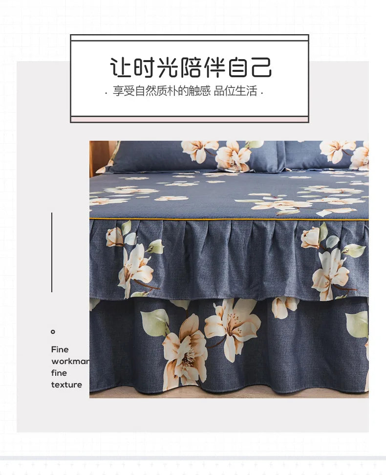 A dark blue printed bed skirt featuring floral patterns and a fine texture.