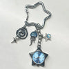 Silver star pocket watch keychain featuring a spiral charm and a blue-tinted clock face.