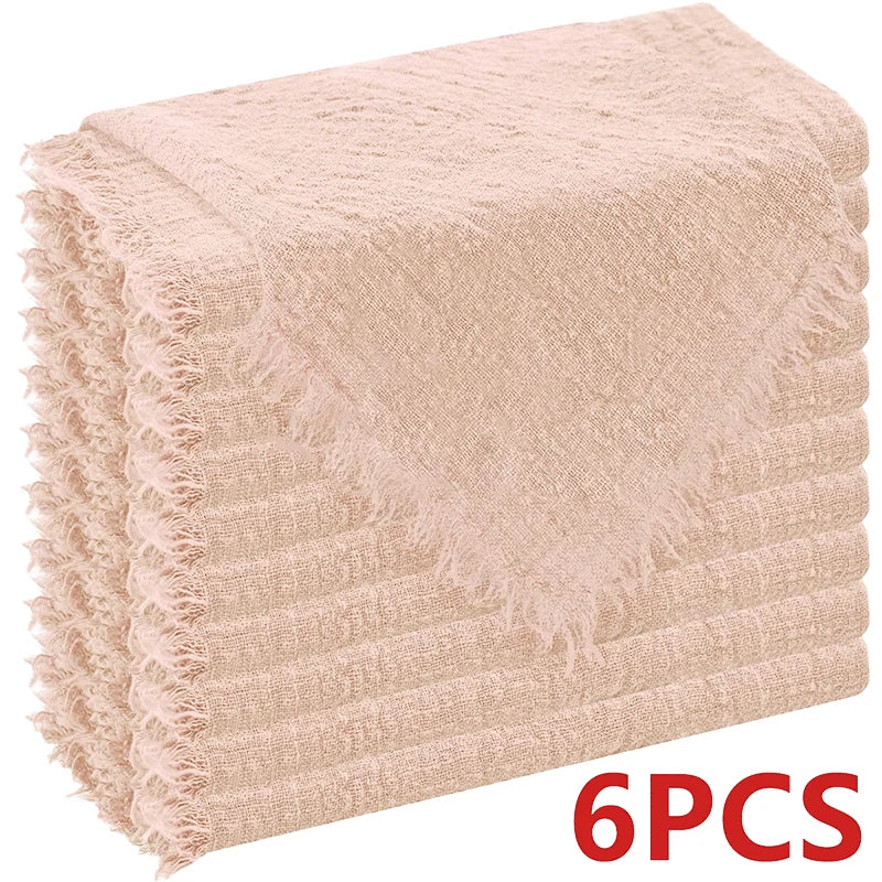 A stack of six light pink textured cloth napkins