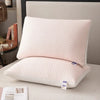 A white quilted 3D cooling therapy pillow resting on a light-colored surface.
