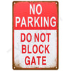 A vintage red and white metal sign with the text NO PARKING DO NOT BLOCK GATE.