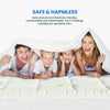 A family of four smiling while lying on a white bamboo viscose mattress topper.