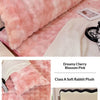 A fluffy pink rabbit plush long pillowcase displayed on a bed with a white blanket and a photo.