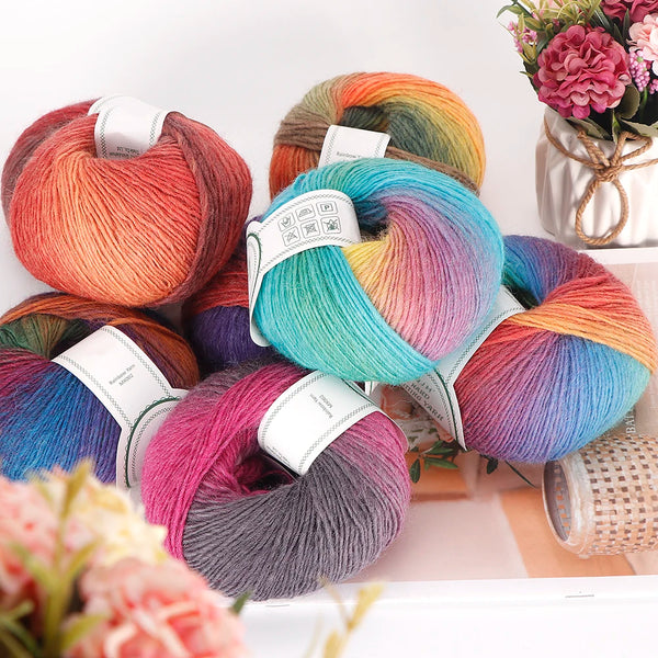A collection of multi-colored wool yarn skeins in various shades of pink, orange, blue, and green.